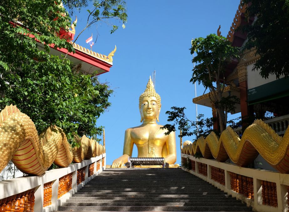 A flight of stairs reaching up to the Golden Buddha on the hill