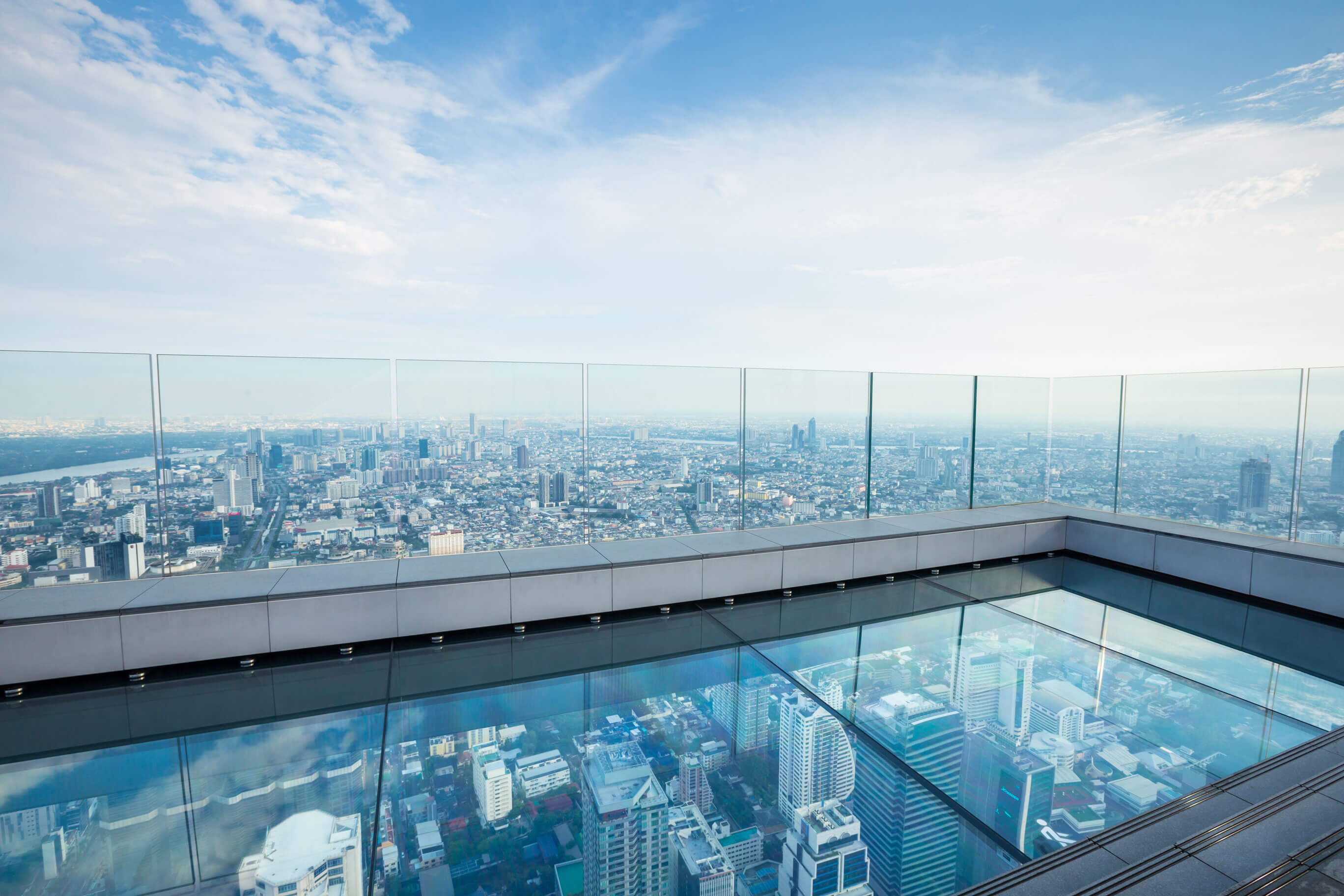 The view of city skyline from the glass tray of Mahanakhon SkyWalk