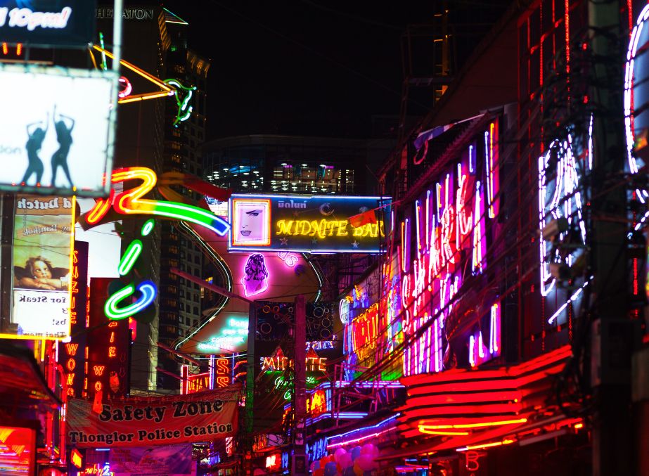 Neon lit sign boards Soi Cowboy is adult entertainment district in Bangkok